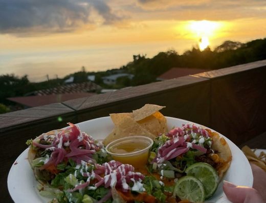 Taco plate with a sunset over the ocean at Shaka Tacoz in Captain Cook, Hawaii